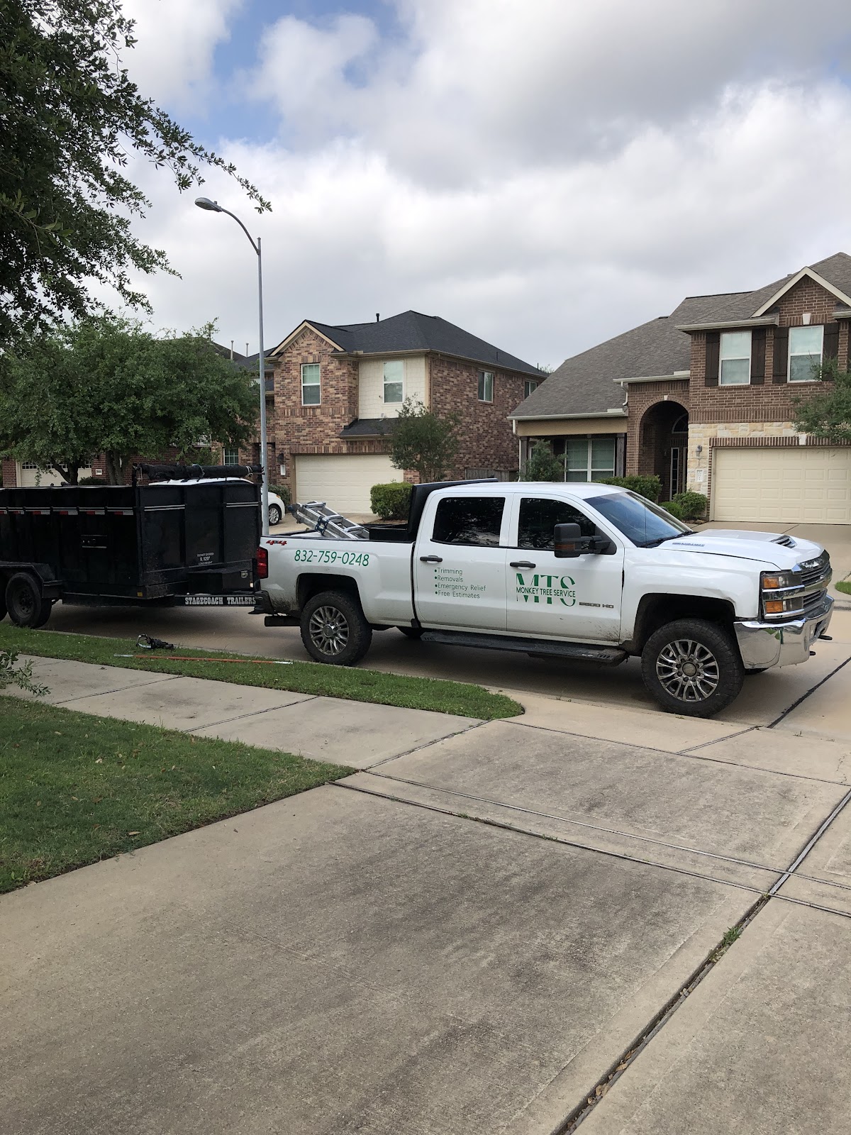 Monkey Tree Service branded truck at a residential job